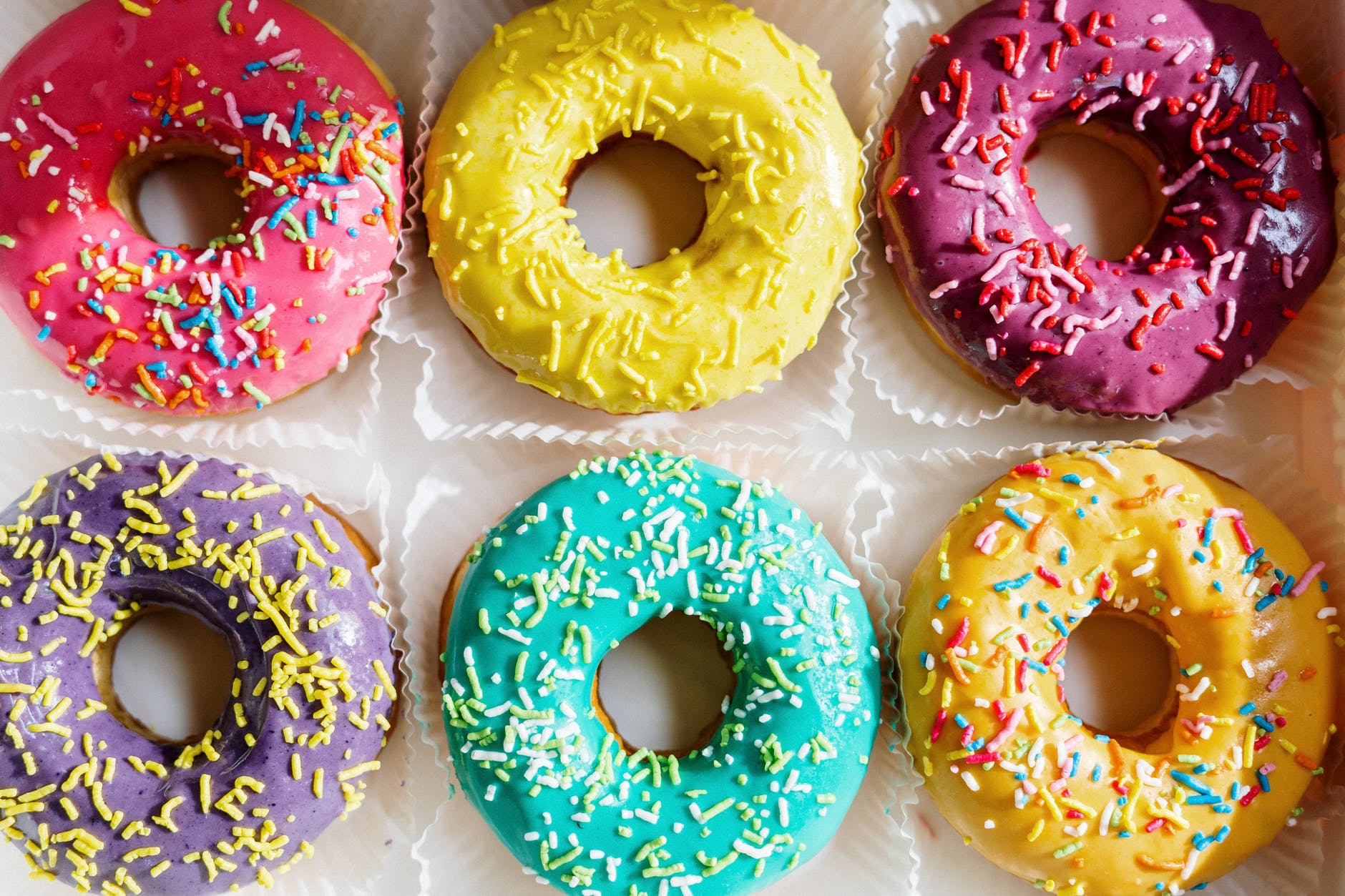 pink doughnut on white textile