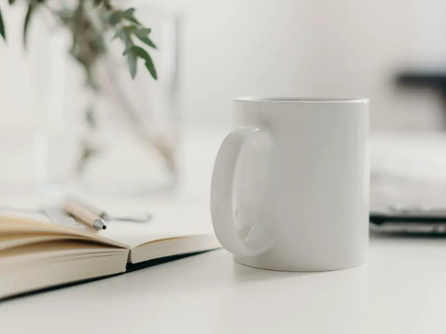 white ceramic mug on table