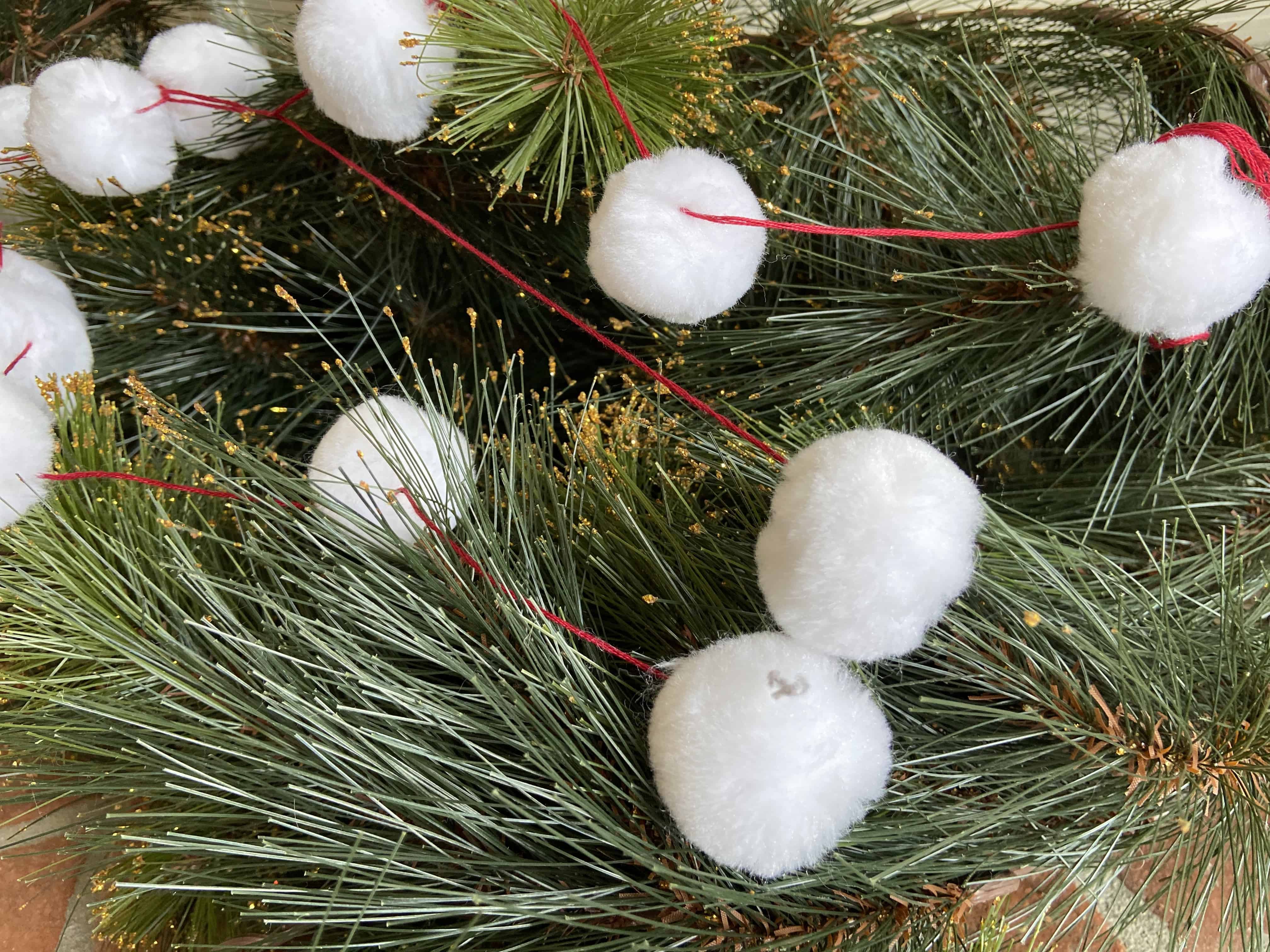 Simple Christmas pom pom garland craft for kids.