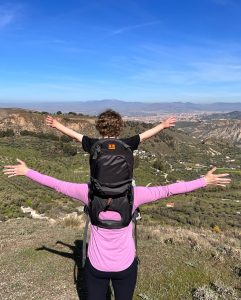 Child in Minimeis carrier on top of mountain