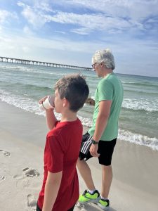 People walking on the beach drinking coffee