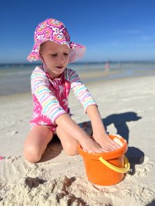 Girl playing in sand at Panama City Beach