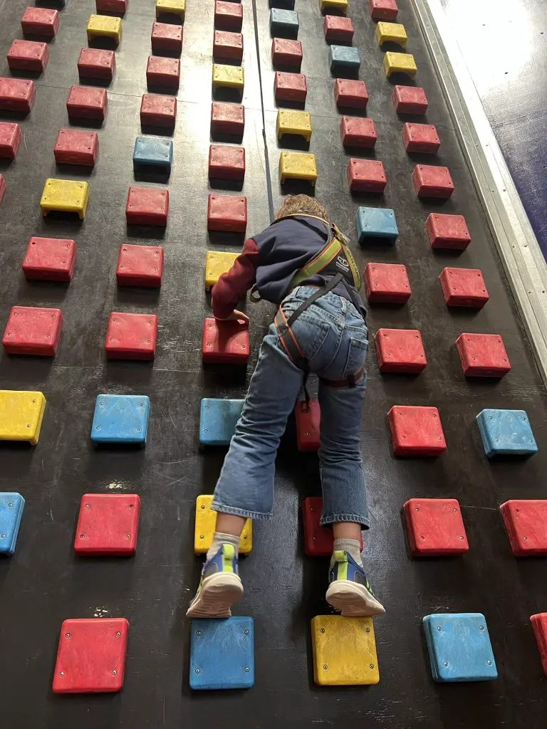 Child climbing indoor rock wall