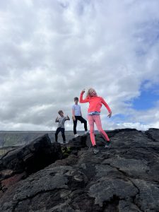 Hawaii Volcanoes National Park kids on lava field by ocean